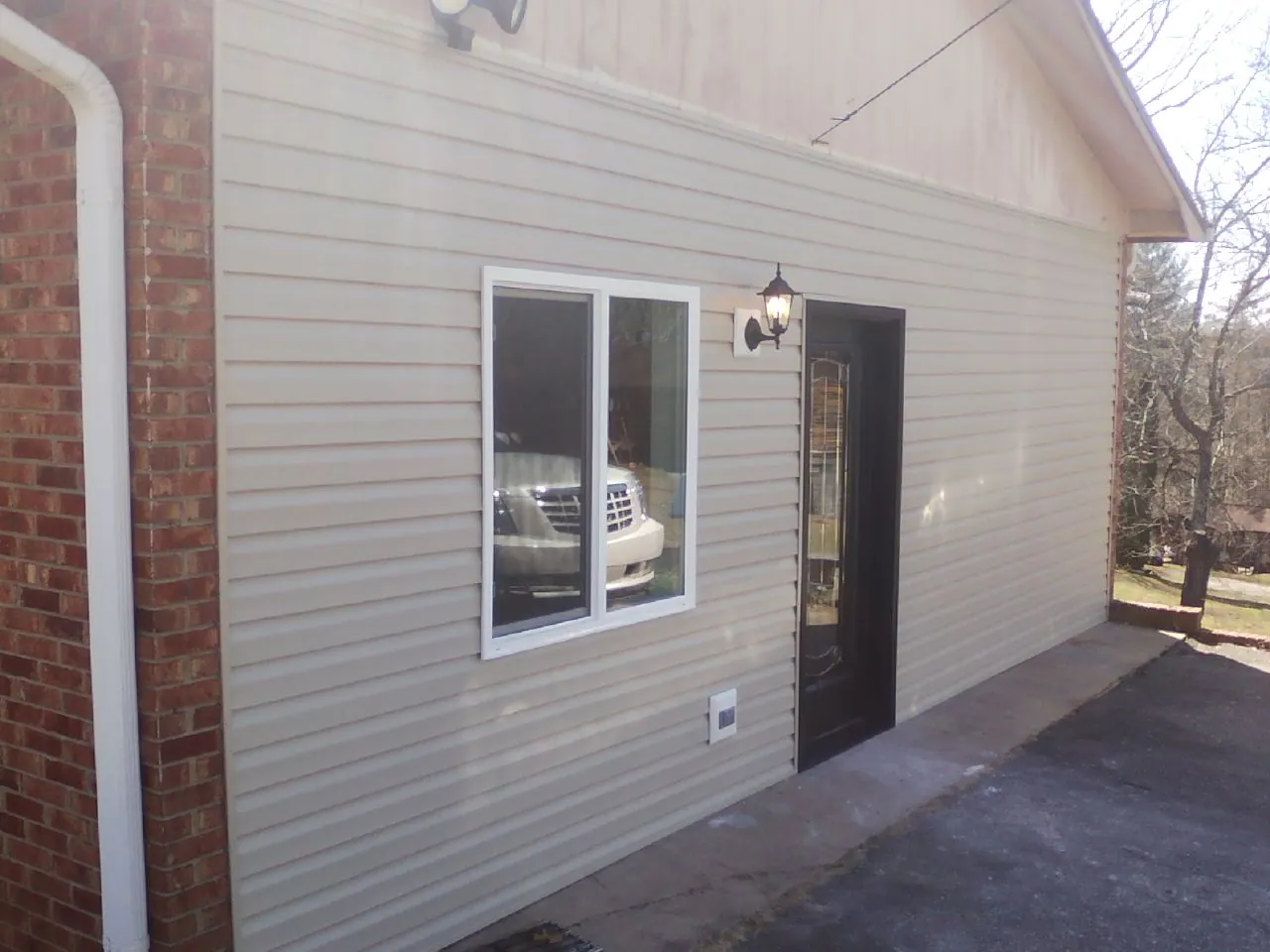 New vinyl siding and entry door on a room addition in Herculaneum